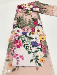 a scarf with flowers and leaves on it