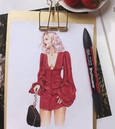 a drawing of a woman in a red dress on a clipboard next to strawberries