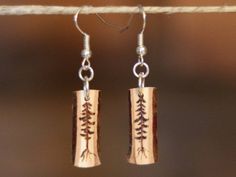 the earrings are made out of wood and have silver earwires with small leaves on them