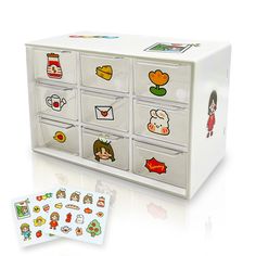 a white drawer with many drawers and stickers on the front, along with two matching cards