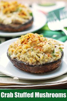 crab stuffed mushrooms on a white plate with text overlay that reads crab stuffed mushrooms