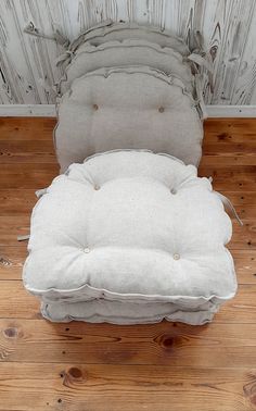 an old chair is sitting on the floor in front of a wood paneled wall