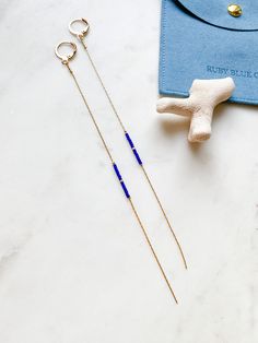 ABOUT THIS PIECE:  Super lightweight pair -  comfortable for all day wear.  Handcrafted sustainable earrings entailing teeny tiny indigo and gold seed bead and 14k gold plated hardware. Approximately 6" long. Versatile pair that can be dressed up or down.  CARE: To preserve your piece, avoid getting water/chemicals on it (e.g. showers/perfume). NOTE: We use standard shipping to mail our orders, this service does not come with a tracking number. If you would like a tracking number or would like y Indigo And Gold, Earring Displays, Lightweight Earrings, Dangly Earrings, Sustainable Jewelry, Beaded Dangle Earrings, Light Weight Earrings, Free Gift Wrapping, Beaded Dangles