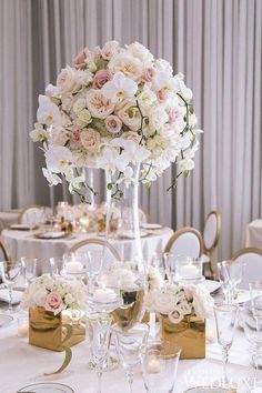 the centerpieces are filled with white and pink flowers