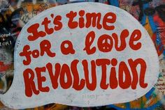 graffiti written on the side of a wall that says it's time for a love revolution