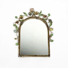 a mirror with flowers and leaves on it