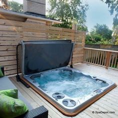 a hot tub sitting on top of a wooden deck