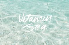 the word vitamin sea written in water with rocks and sand on it's bottom