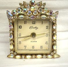 an old clock is adorned with jewels and stones for the lady's birthday or special occasion