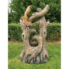 a statue of a squirrel on top of a tree stump