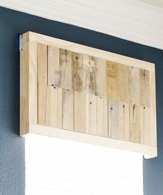 a window sill made out of wooden planks on the side of a wall