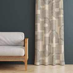 a chair sitting in front of a window next to a wall with a curtain on it