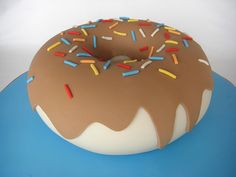 a chocolate frosted donut with sprinkles on top sitting on a blue plate