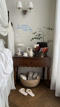 a bedroom with a bed, table and white curtains