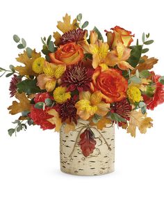 a vase filled with lots of colorful flowers