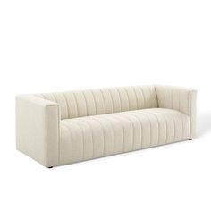 a white couch sitting on top of a white floor