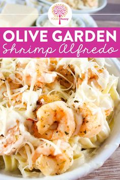 a white bowl filled with shrimp alfredo pasta and garnished with parmesan cheese