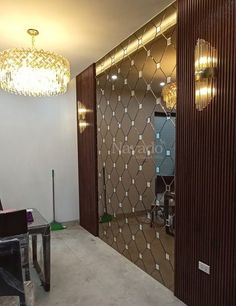 a living room with a glass door and chandelier