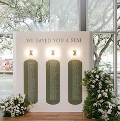 the wedding seating is displayed in front of two large windows