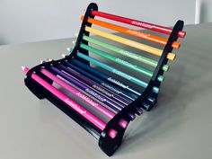 there are many different colored pencils in this holder