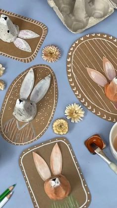 some paper plates with bunnies and flowers on them next to a cup of coffee