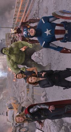 the avengers are standing together in front of a city