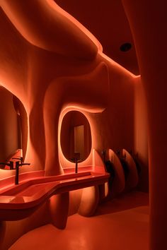 a bathroom with red walls and sinks in it