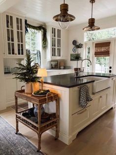 a large kitchen with an island in the middle and lots of cabinets on both sides