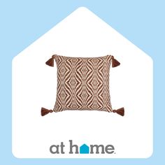 a brown and white pillow sitting on top of a blue background with the words at home