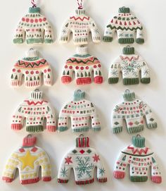 christmas sweaters and mittens ornament ornaments on a white surface with snowflakes