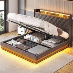 a bed with an open drawer underneath it in a room next to a large window