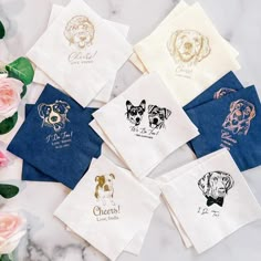 six different types of dog handkerchiefs on a marble table with pink flowers and greenery