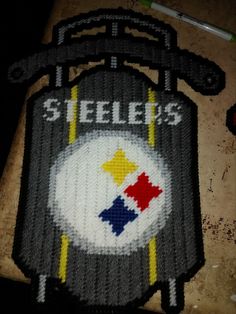 a close up of a knitted sign with the word steele's on it