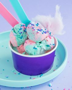 a bowl filled with ice cream and sprinkles on top of a plate