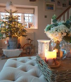 a living room filled with furniture and a christmas tree