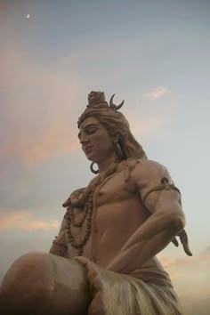 a statue of a man sitting on top of a horse in front of a cloudy sky