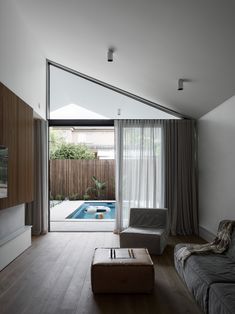 a living room with a pool and sliding glass doors