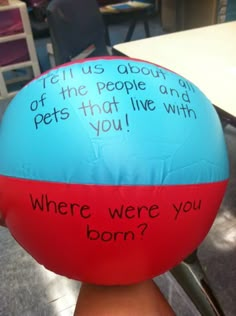 a blue and red ball sitting on top of a table