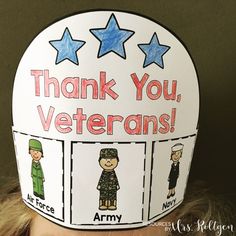 a child wearing a paper hat with pictures of veterans and the words thank you, veterans