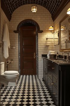 a white toilet sitting next to a bathroom sink under a mirror on top of a tiled floor