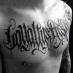 a man's chest with the word tattoo on it and his name written in cursive writing