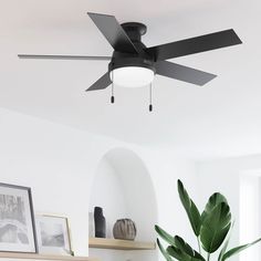 a black ceiling fan in a white living room