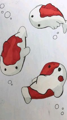 three red and white fish with bubbles floating in the air on a sheet of paper