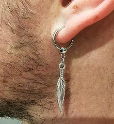 One clip-on earring, Feather earring, Feather dangle, Men earring, Silver feather, Symbol feather dangle Gift for him Crow feather men gift. Antique silver alloy feather size is 1.8 Inches ( 47 mm) Charm length 28 mm Circle size 14 mm Earrings Men Aesthetic, Dangling Earrings Men, Dangle Earrings Men, Mens Dangle Earrings, Feather Symbol, Crow Feather, Earrings Men, Magic Charms, Unisex Earrings