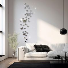 a living room with white furniture and black accents