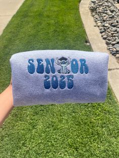 SENIORS 2025! Order your senior 2025 embroidered sweaters that will last a lifetime! You can follow me on instagram @MAMACUSTOMS for more of my work on there. I do customs as well, if you're wanting a different character send me a message on etsy or instagram. SWEATSHIRT/TEE INFO Embroidered on Heavy Blend Fleece Crew offers ultimate comfort and durability. Crafted from a 50/50 blend of cotton and polyester, this 8 oz. fleece crew features a tear-away label, pill-resistant air jet yarn, and doub Senior Merch Ideas, Senior Sweaters, Senior Crewneck, Seniors Hoodies, Senior Picture Sweatshirt, Senior Class Sweatshirts, Seniors Sweatshirt, Senior Sweatshirts Ideas, Senior Hoodies Design Ideas