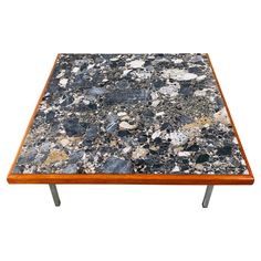 a coffee table made out of granite and wood with metal legs on an isolated white background