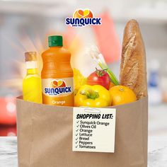 a grocery bag filled with orange juice, lemonade, and other foodstuffs