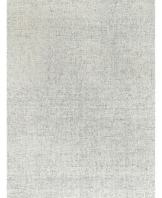 a white rug with small squares on the top and bottom, along with a light gray background