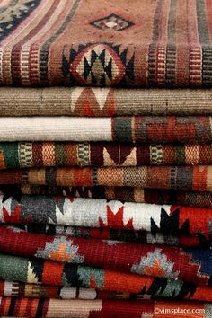 a pile of colorful rugs sitting next to each other